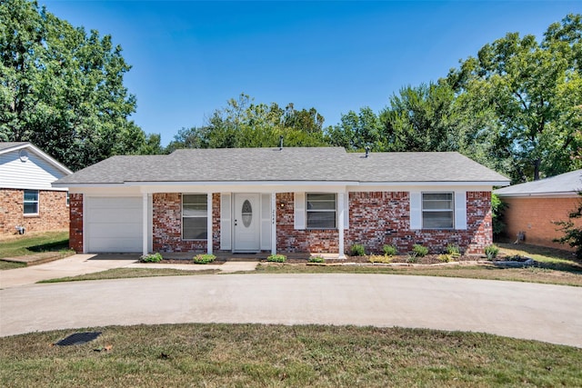 ranch-style home featuring brick siding, an attached garage, and concrete driveway