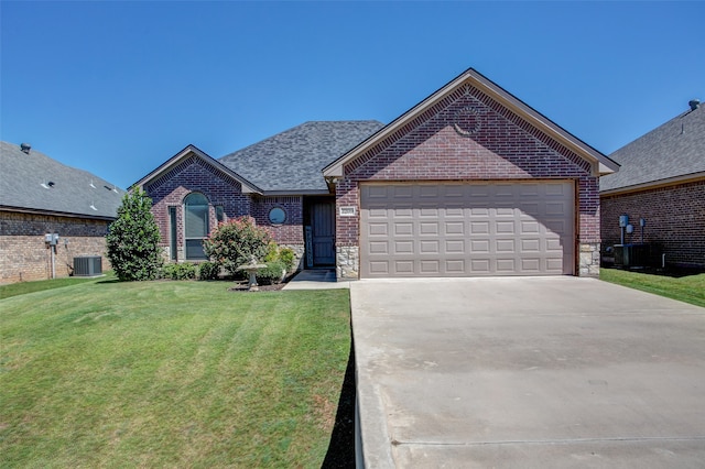 view of front facade featuring a front yard, a garage, and central AC unit