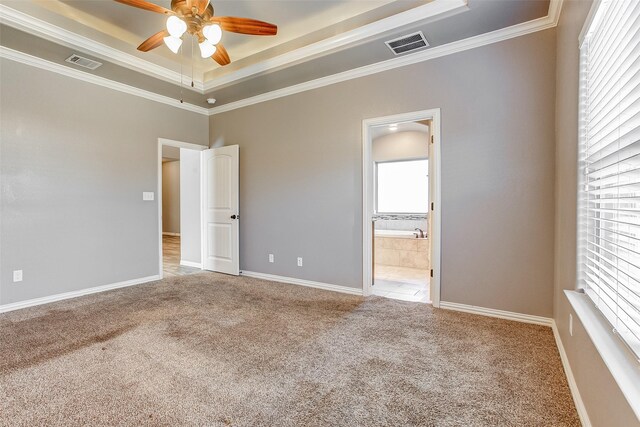 unfurnished bedroom with light colored carpet, multiple windows, ornamental molding, and ceiling fan