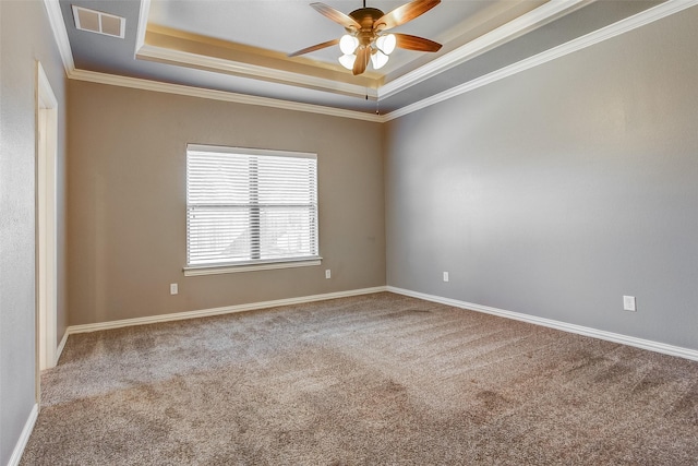 spare room with carpet floors, a raised ceiling, ceiling fan, and ornamental molding