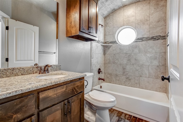 full bathroom with vanity, toilet, tiled shower / bath, and hardwood / wood-style flooring