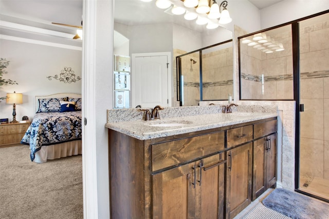 bathroom with vanity, a shower with door, and ceiling fan