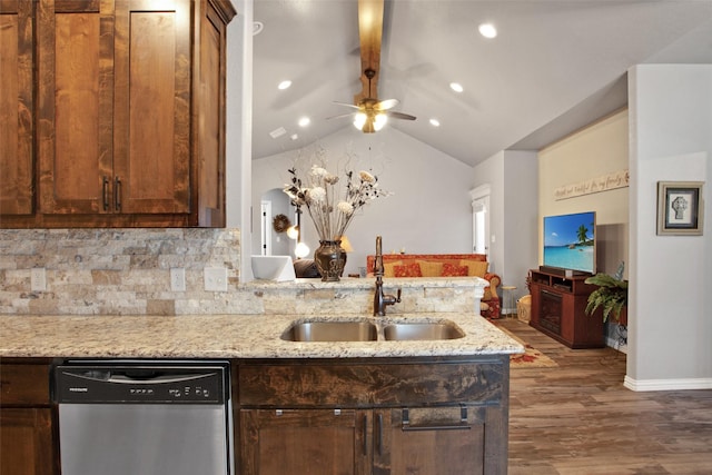 kitchen featuring dishwasher, sink, vaulted ceiling with beams, light stone counters, and dark hardwood / wood-style flooring