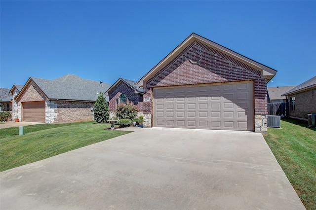 view of front of home with central AC unit, a garage, and a front lawn