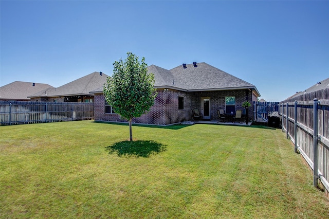 rear view of house with a yard