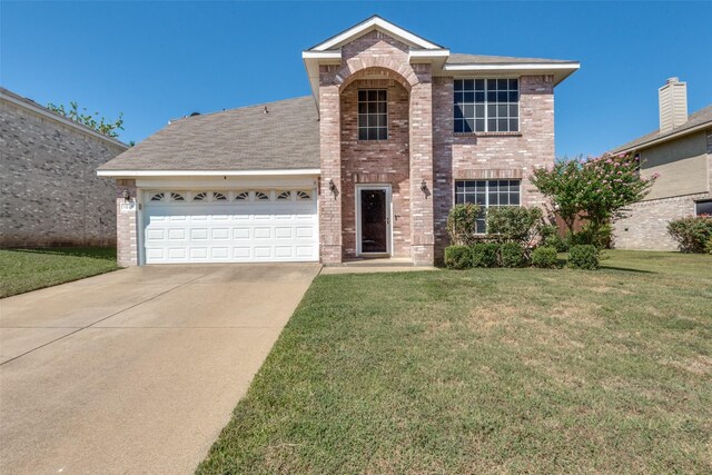 view of property featuring a garage and a front yard