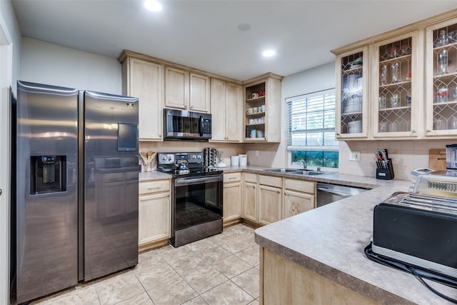 kitchen featuring light brown cabinetry, tasteful backsplash, stainless steel appliances, sink, and light tile patterned flooring