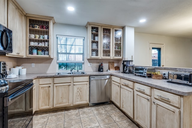 kitchen with dishwasher, sink, electric stove, and backsplash