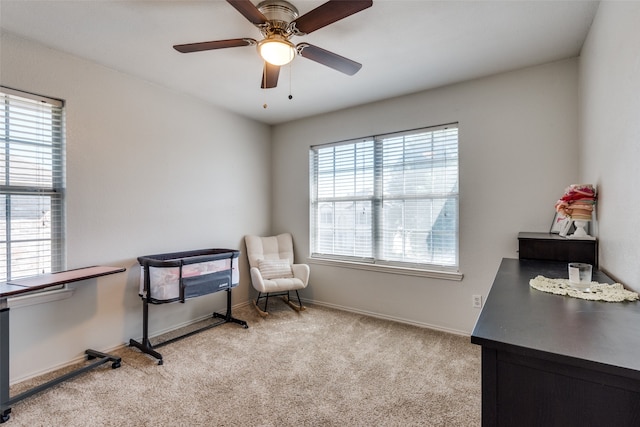 office area with ceiling fan, light colored carpet, and plenty of natural light