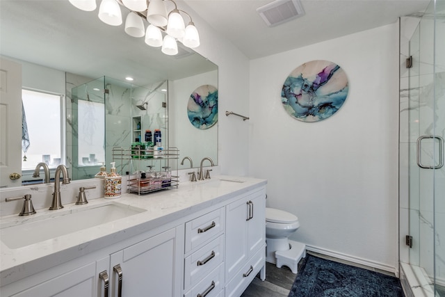 bathroom with toilet, an enclosed shower, a chandelier, and vanity