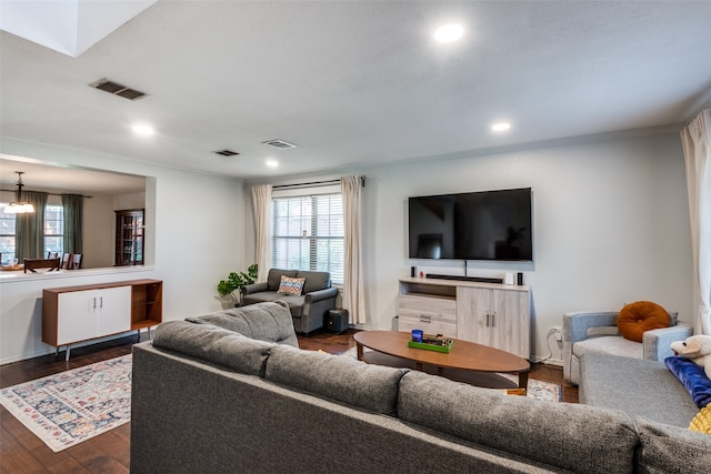 living room featuring dark hardwood / wood-style floors and a notable chandelier