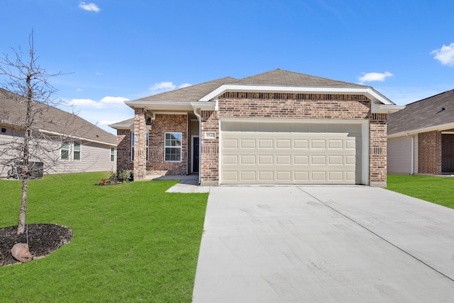 view of front of house featuring a front yard, concrete driveway, brick siding, and an attached garage