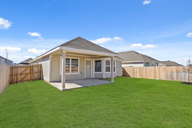 back of property featuring a fenced backyard, a lawn, and a patio