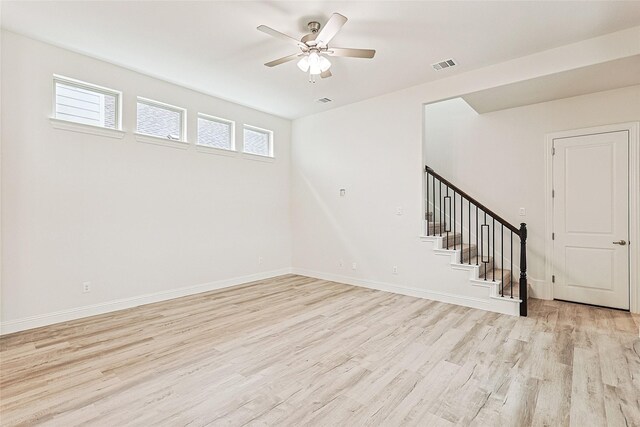 basement with light wood-type flooring and ceiling fan