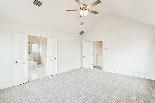 unfurnished bedroom featuring ceiling fan, ensuite bathroom, lofted ceiling, and light carpet