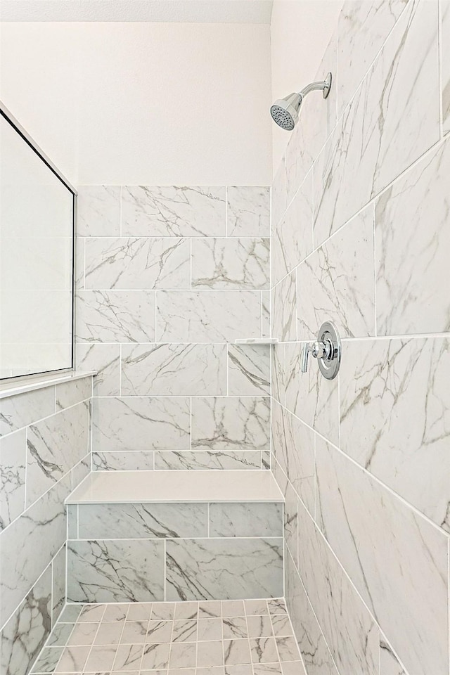 bathroom with a tile shower