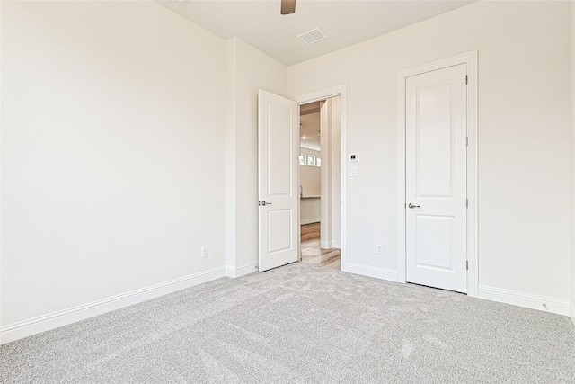 unfurnished bedroom featuring light carpet and ceiling fan