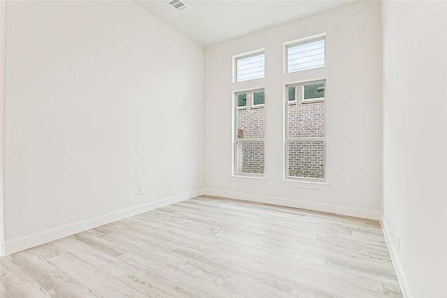 spare room with light hardwood / wood-style floors