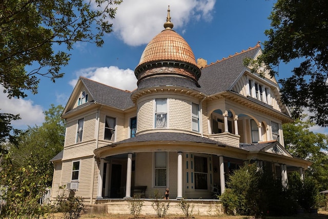 rear view of house with covered porch