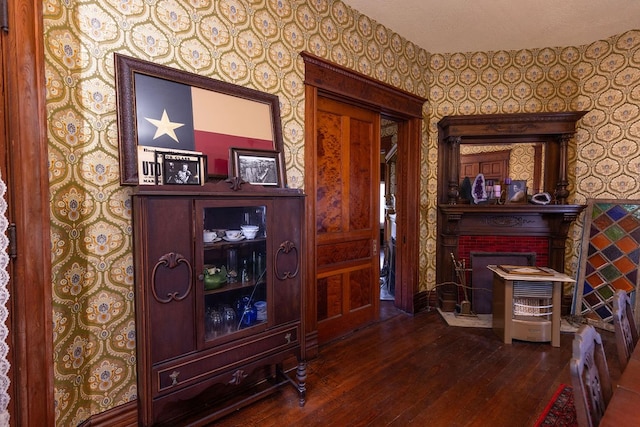 interior space with a textured ceiling and hardwood / wood-style floors