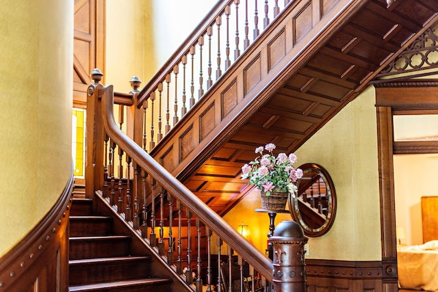 staircase with coffered ceiling and wood ceiling