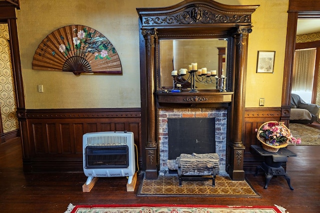 living room with heating unit and dark hardwood / wood-style floors