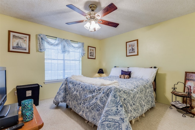 carpeted bedroom with a textured ceiling and ceiling fan