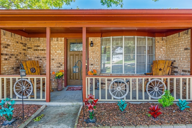 view of exterior entry with covered porch