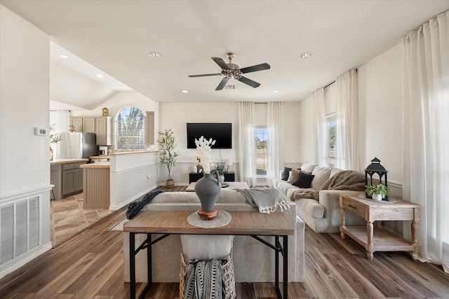 living room featuring dark wood-type flooring, ceiling fan, and lofted ceiling