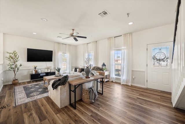 living room with hardwood / wood-style flooring and ceiling fan