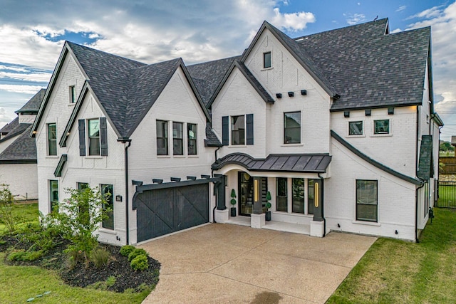 view of front of home with a front yard and a garage