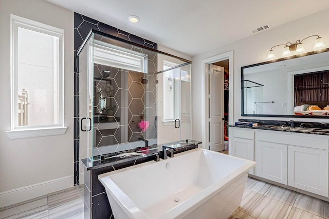 bathroom with vanity, separate shower and tub, and tile patterned flooring