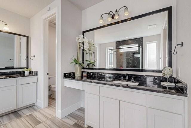 bathroom with toilet, walk in shower, vanity, and hardwood / wood-style flooring