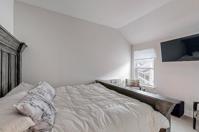 carpeted bedroom featuring vaulted ceiling