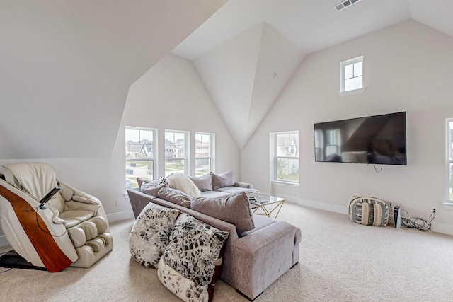 carpeted living room with a wealth of natural light and lofted ceiling