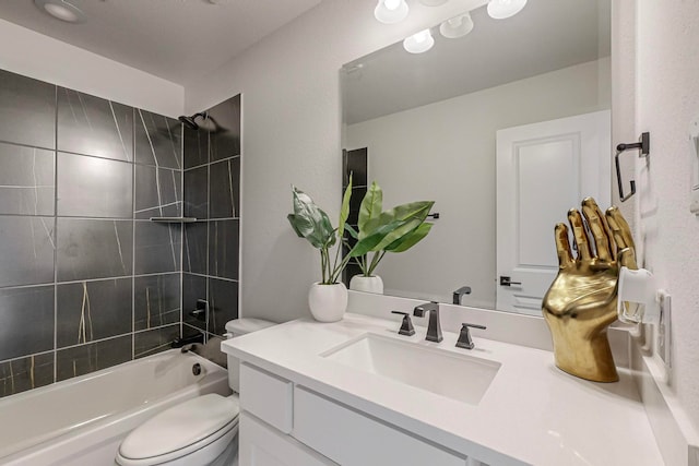 full bathroom with toilet, tiled shower / bath, and vanity