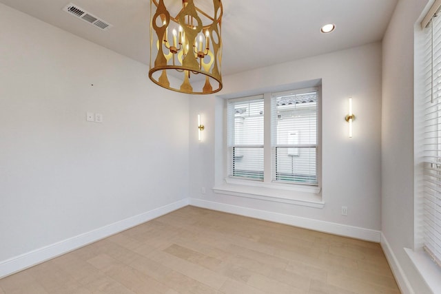 empty room with a notable chandelier