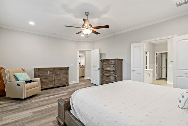 bedroom with ensuite bathroom, light hardwood / wood-style flooring, ceiling fan, and crown molding