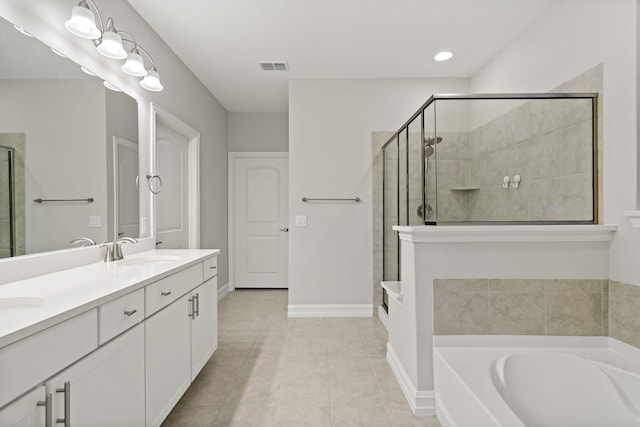 bathroom with tile patterned flooring, vanity, and shower with separate bathtub