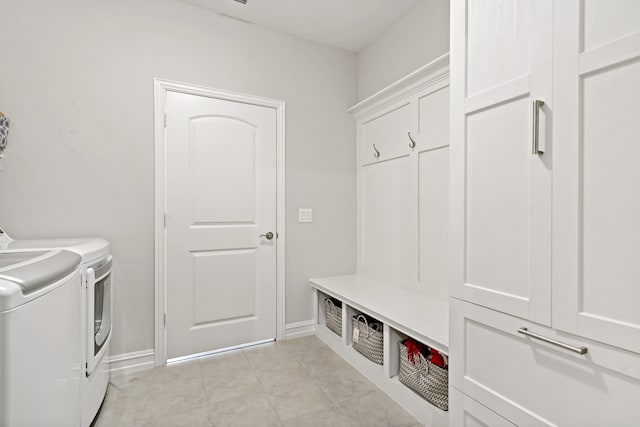 laundry area featuring cabinets and washer and clothes dryer