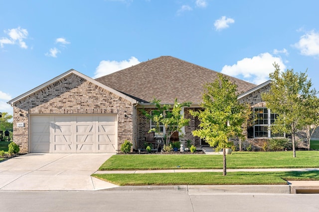 view of front of home with a garage and a front lawn