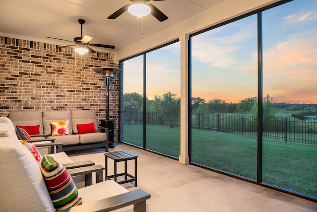 living room featuring light carpet, a wall of windows, ceiling fan, and brick wall