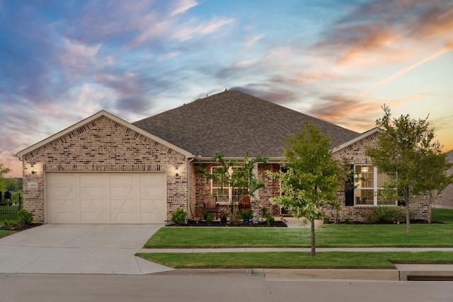 view of front facade with a lawn and a garage