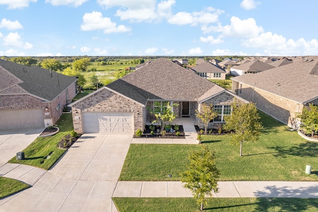 view of front of home with a front yard and a garage