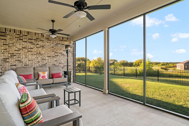 sunroom featuring ceiling fan