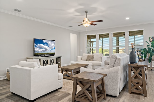 living room with hardwood / wood-style floors, ceiling fan, and crown molding