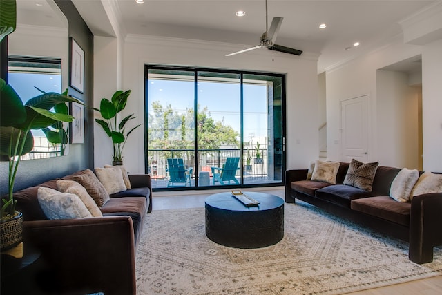 living room featuring ceiling fan, ornamental molding, and hardwood / wood-style flooring