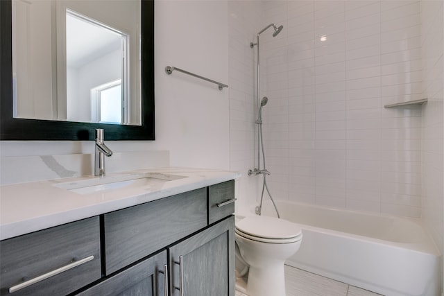 full bathroom featuring vanity, toilet, and tiled shower / bath