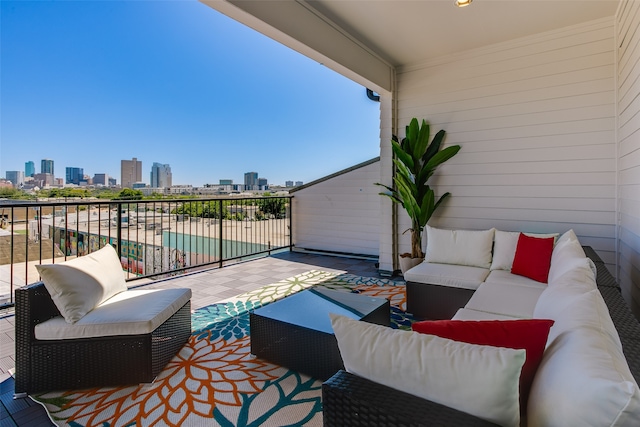 view of patio featuring an outdoor living space and a balcony