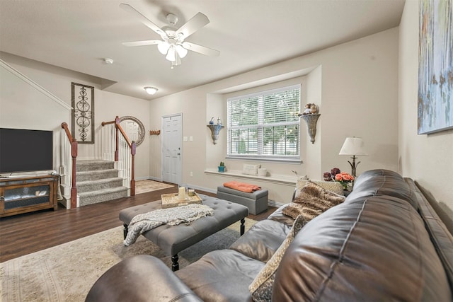 living room featuring wood-type flooring and ceiling fan